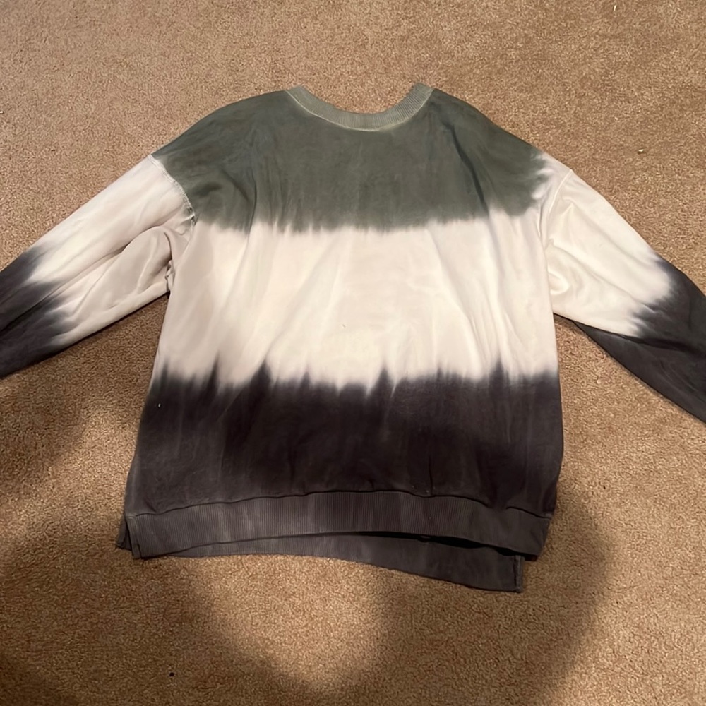 This is a dark green and white long sleeve American Eagle shirt.